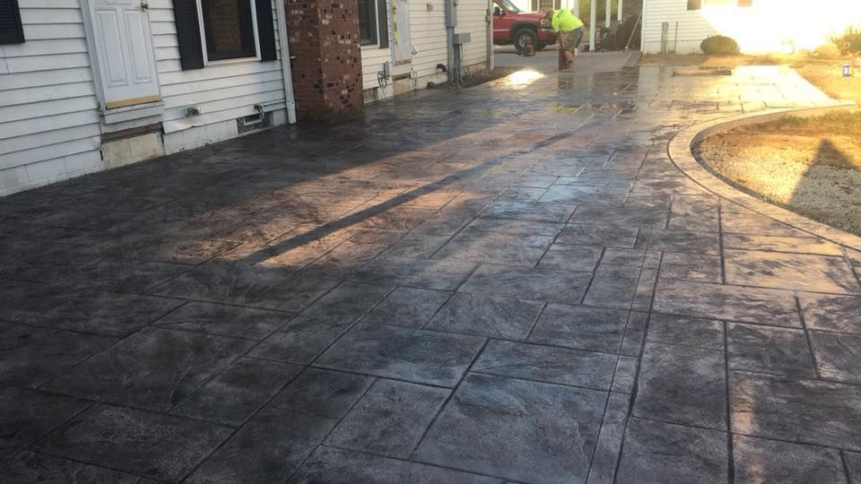 Charcoal stamped concrete patio walkway